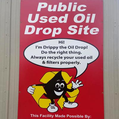 Sign on Albany Recycling Center's building promoting that they are an official Pubic Used Oil Drop Site
